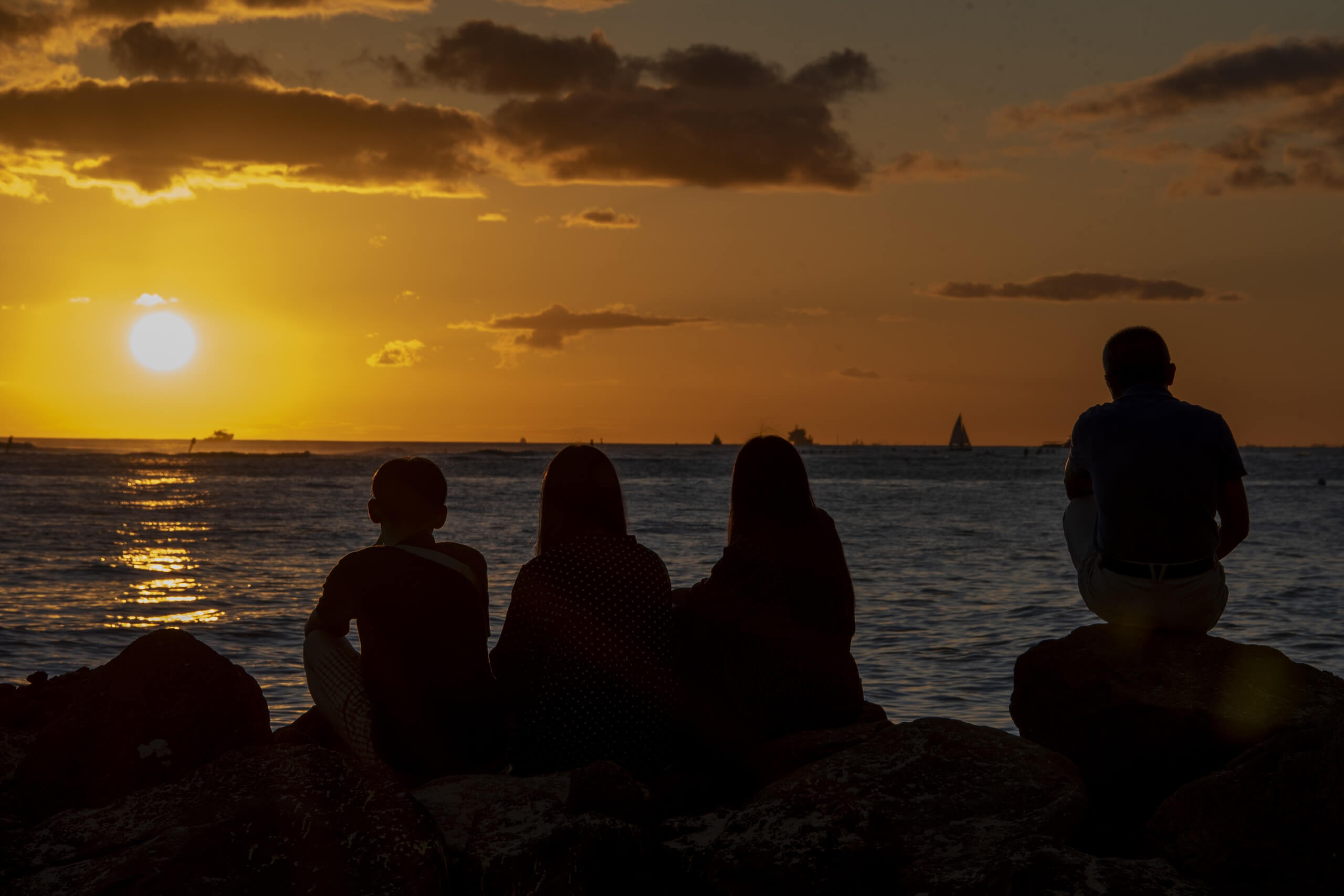 Coastal Landscape Fine Art titled Dreaming, featuring silhouettes of people watching a Honolulu sunset.