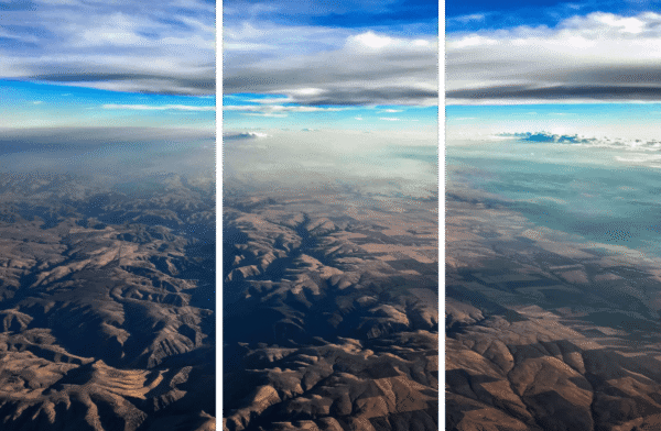 Abstract Landscape Fine Art titled Earth and Sky, aerial view of rugged terrain and blue sky.