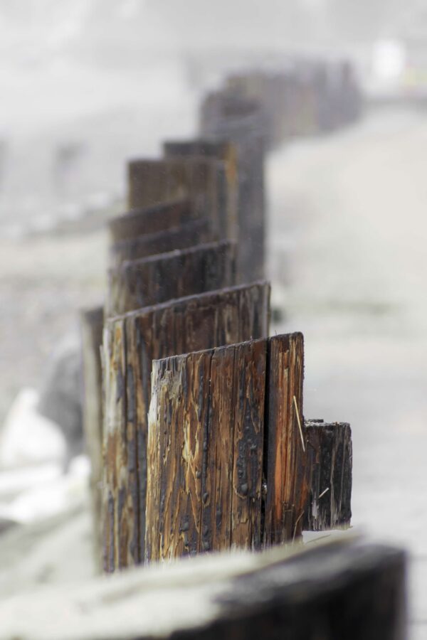 Ocean Landscape Fine Art titled Follow Me, featuring a curved row of pylons in Northern California.
